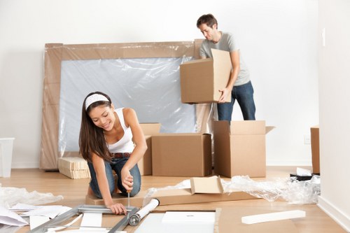 Piano removal team carefully moving an upright piano in Surrey