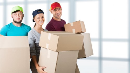 Worker assessing lifting risks before moving items