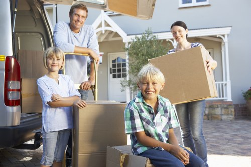 Packed moving boxes and furniture prepared for urgent local removals